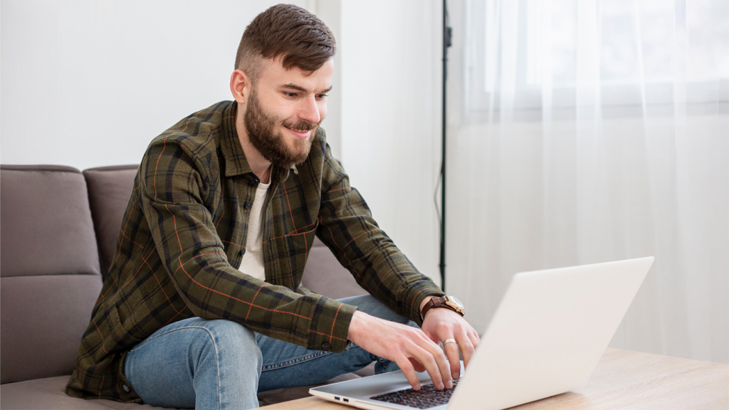 Guy using laptop, smiling